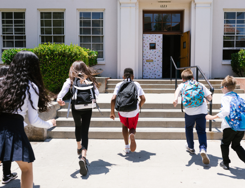 Kids going up the steps to school