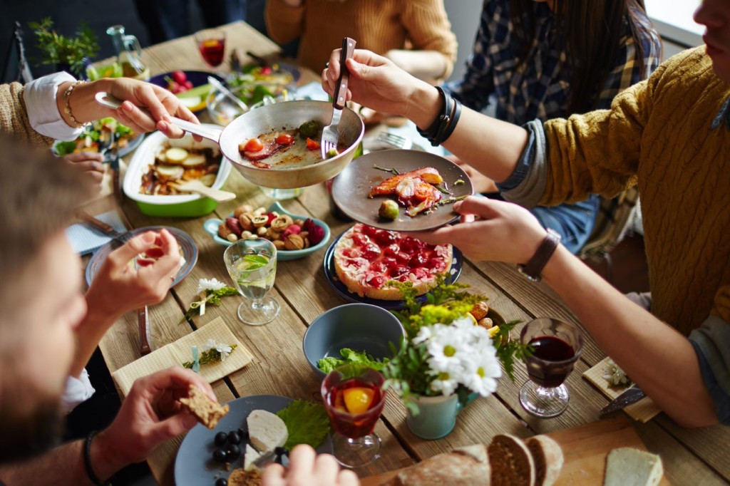 People sharing foods around a table